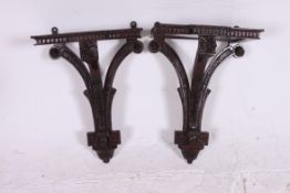 A pair of 20th century mahogany carved clock brackets,