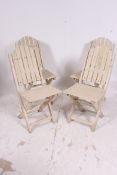 A set of 20th century shabby chic wooden painted garden chairs that fold.