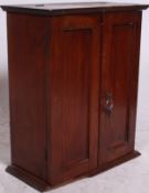 A mahogany early 20th century smokers cabinet companion having twin opening doors and hinged top