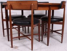 A teak G-plan dining table and 4 dining chairs designed in the manner of Koford Larsen.