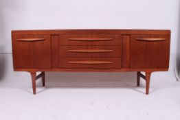 A retro 1970's teak wood low Danish inspired sideboard of small proportions  comprising a series of