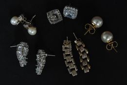 A selection of 5 pairs of glamorous silver and earrings some set with  simulated pearl.