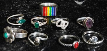 A selection of 10 silver dress rings set with gem stones of contemporary design.
