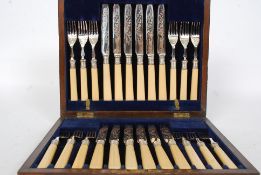 A mahogany cased set of silver hallmarked collar knives and forks with baize lined interior.