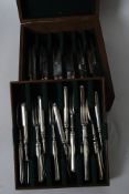 A 19th century silver handled cutlery set bearing rubbed markings set within a good oak cutlery box