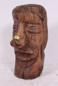 A 20th century carved wooden figural head bust, loosely in the style of the Easter Island Moai,