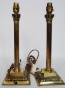 A pair of Corinthian column lamp bases - cylindrical ribbed stems on square terraced bases.