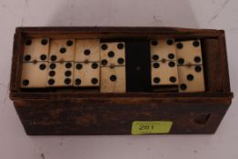 An early 20th century bone and ebony domino set complete with the wooden original case