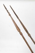 A pair of Polynesian tribal spears of hardwood form having tapering shaft - 6ft plus with carved