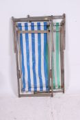 A pair of 1970's beech wood canvas upholstered folding deck chairs,