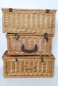 Three whicker picnic hampers each with leather straps,