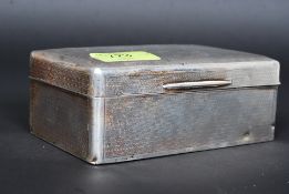 A silver table top hallmarked large cigarette case with central cartouche bearing monogram.