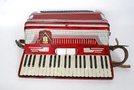 A Frontalini accordion made in Italy in original case having a red faux marble finish