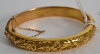 An early 20th century ladies rococo  gold plated bracelet with foliate engraving complete with the
