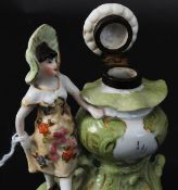 A 19th century German porcelain inkwell bearing blue mark having brass hinged lid with urn and lady