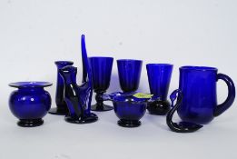 A collection of Bristol Blue glass being signed by the artist Steve Baker to include candlesticks,