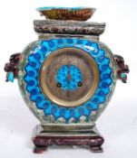 A French majolica 8 day mantel clock in an Aesthetic Movement porcelain Chinese influenced case