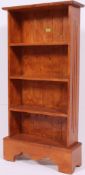A Victorian style pine bookcase cabinet raised on a bracket base with upright body.