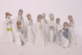 LLADRO NAO; A collection of 10x assorted Lladro Nao figurines of children, in various designs.