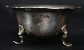 An Edwardian silver hallmarked table salt raised on cabriole legs with pad feet.
