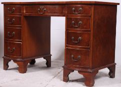 A Georgian style mahogany bow front twin pedestal desk by Bevan Funnel - Reprodux.