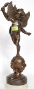 A wonderful late 19th / early 20th century large bronze statue of a torch bearing cherub atop a