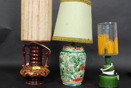 A collection of three retro table lamps, including one by Beswick. Each with a decorative shade.