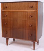A good 1970's Retro / vintage four drawer upright bedroom  chest of drawers being raised on tapered
