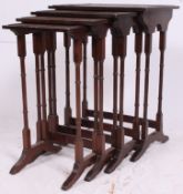 An Edwardian style flame mahogany quartetto nest of tables having bamboo carved style legs united