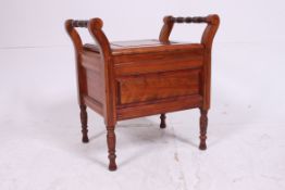An Edwardian mahogany piano stool having handles to the sides of the upholstered central seat.
