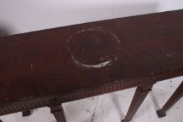 A Regency Irish style mahogany  console table having reeded tapered legs with spade feet having