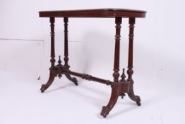 A Victorian mahogany writing table desk raised on turned supports united by stretchers having