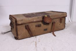 A 20th century canvas and leather bound steamer trunk  having brass locks with notation to the top