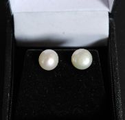 A pair of silver and pearl earrings,