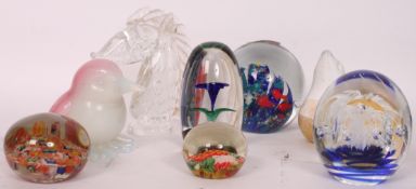A collection of 8x assorted glass paperweights to include millefiori, horses head, seal and others.