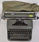A retro / vintage Olympia typewriter De Luxe in grey with silver logo