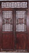 A fabulous pair of 20th cenutry Chinese hardwood doors having recessed lower panels with fret