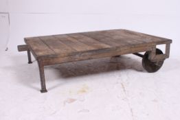 A good Industrial cast metal and wooden planked trolley coffee table.