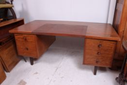 A Waring & Gillows 1960's Air Ministry mahogany twin pedestal writing desk having a series of
