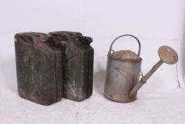 A vintage galvanised metal mid 20th century large watering can together with 2 metal military style