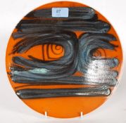 A 20th century Poole Pottery ' Delphis ' series bowl charger with central design being marked to
