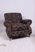 A blue and gold Damassk style Windsor Armchair with rolled arms and brass castor feet detailing