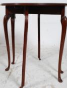 A 1930's mahogany drop leaf sutherland table raised on cabriole legs with pad feet having gate legs