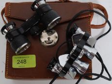 Two pairs of miniature binoculars / opera glasses, within an unassociated case.