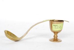 A Victorian rare brass egg ladle along with a Victorian turned brass egg cup