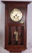 A 1920's oak cased drop dial 8 day wall clock striking on a chime.