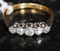 An 18ct gold and platinum diamond ring, 5 stones. Approx 50pts.