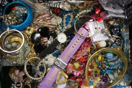 A collection of assorted costume jewellery to include watches, bracelets, brooches and other items.