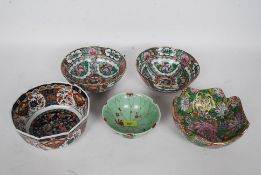 A collection of Chinese bowls each in a different design with character marks to base
