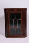 A vintage Georgian style oak country hanging cabinet having glass door to front with gallery